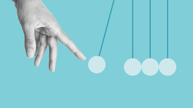Hand launches pendulum balls. Start-up concept. Newton's cradle. Sphere hanging on threads. Launch Business Ideas Creativity Concept