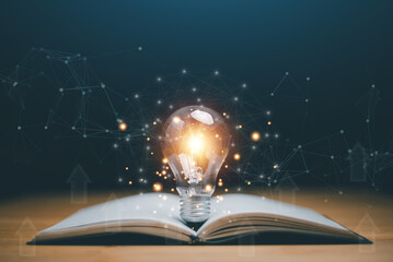 Glowing light bulb on a book, Inspiring from read concept, Educational knowledge and business education ideas, Innovations, self-learning, knowledge and searching for new ideas. Thinking for new idea. - obrazy, fototapety, plakaty