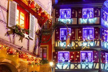 Decorated and illuminated half-timbered house in Old Town at Christmas night, Colmar, Alsace, France - obrazy, fototapety, plakaty