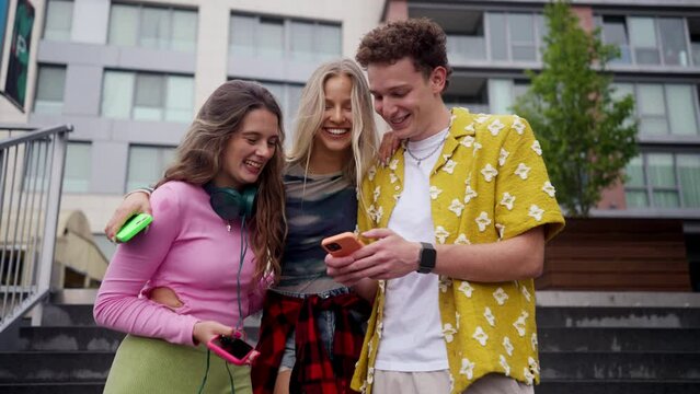 Generation z students hanging out together outdoors in the city.