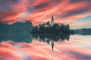 Fototapeta na wymiar lake bled slovenia sunset clouds and light landscape with reflections