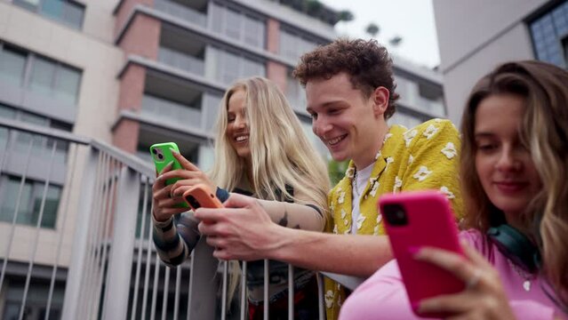 Generation z students hanging out together outdoors in the city.