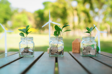 Concept of sustainable money growth investment with glass jar filled with money savings coins...