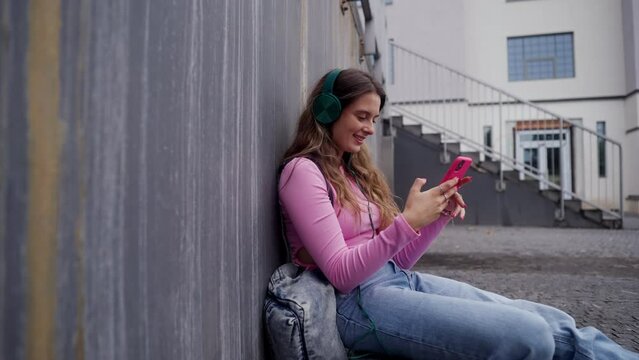 Video of generation z girl student sitting outdoors in the city.