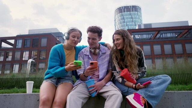 Generation z students hanging out together outdoors in the city.