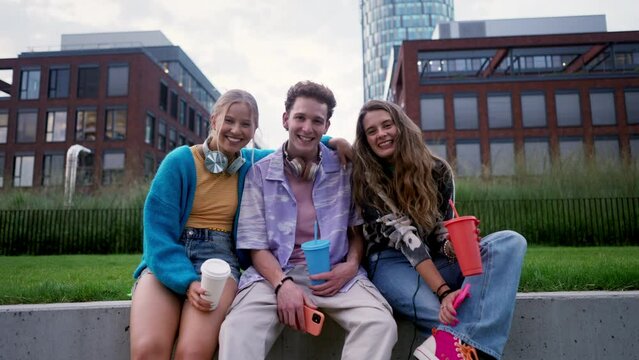 Generation z students hanging out together outdoors in the city.