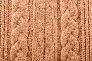 Knitted texture toned with color of the year 2024 peach fuzz