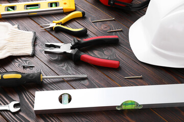 Different modern construction tools on wooden background