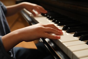 Obraz premium Little child playing piano, closeup. Music lesson