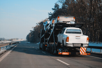 Car Carrier Trailer Truck With Brand New Pick-Up Cars For Sale. Car Transporter Trailer Loaded With...