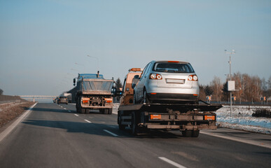 Damaged Hatchback Car Loaded On An Emergency Tow Truck For The Repairs. Roadside Assistance On A...