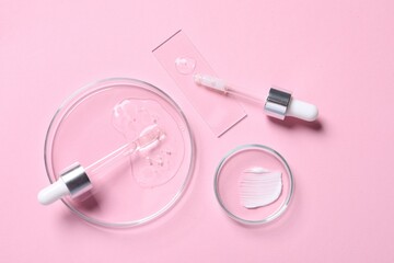 Pipettes, cosmetic serum and petri dishes with samples on pink background, flat lay
