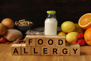 Food allergy. Different fresh products and cubes on wooden table