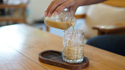pouring coffee into glass cup