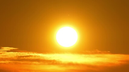 Cinematic view of orange yellow and red sunset sky with clouds. End of the day. Dusk at summer time in Canadian wilderness. Epic sun set with large circle as sun goes down to twilight. Evening sky. - Powered by Adobe
