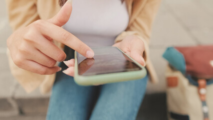 Close-up of woman's hands scrolling social media on mobile phone