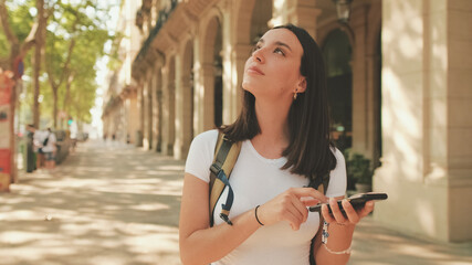 Woman traveler enjoys map app on her mobile phone