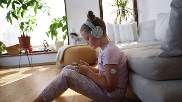 Diabetic girl watching social media content on smart phone.