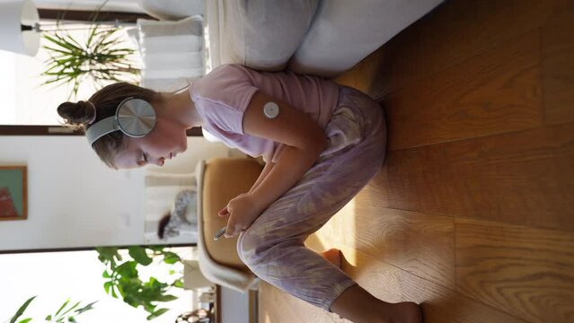 Diabetic girl watching social media content on smart phone.