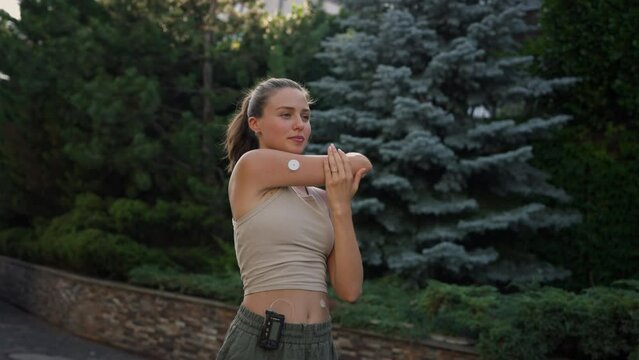 Beautiful diabetic woman preparing for outdoor workout in the city.