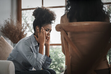 Sad PTSD woman patient in crucial therapy for mental health with psychologist, depression or grief...