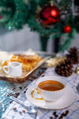 Cup of hot coffee and bakery goods Various waffles and breads are on the table. and decorated with Christmas There is a Christmas tree and various decorations. to celebrate the Christmas festival.