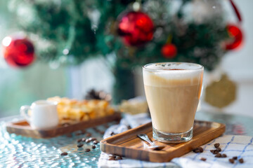 Cup of hot coffee and bakery goods Various waffles and breads are on the table. and decorated with Christmas There is a Christmas tree and various decorations. to celebrate the Christmas festival.