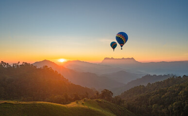 Hot air balloons flying at blue sky background - romantic landscape with two colorful balloons....
