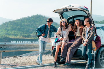 Group of Asian generation z people friends sitting on car trunk looking beautiful nature of...