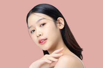 Portrait of young beautiful Asian woman with healthy facial skin in K-beauty make up isolated on pink background.
