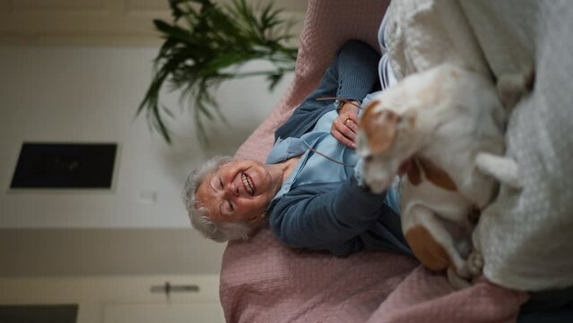 Senior woman enjoying time with her little dog.