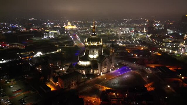 Drone shot of Saint Paul Cathedral with the cityscape of Minnesota in the background at night, USA