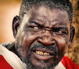 portrait of old man in the yard, botswana village, siting in the yard