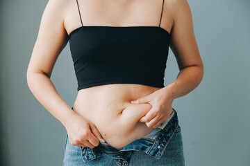 fat woman, fat belly, chubby, obese woman hand holding excessive belly fat with measure tape, woman...