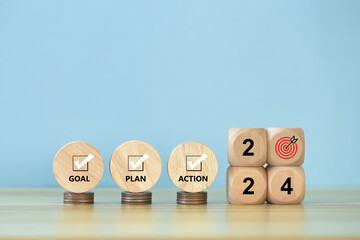 2024 goals of business or life. Wooden cubes with 2024 and goal icon with Goal, Plan, Action on...
