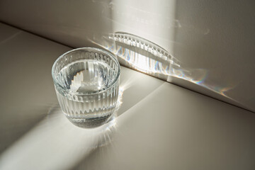 A glass of clean drinking water in the morning sun.