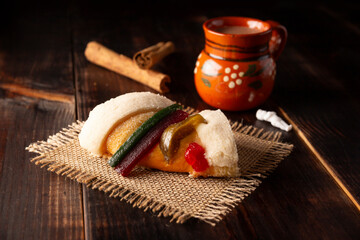 Traditional Kings day cake also called Rosca de Reyes, roscon, Epiphany Cake and with a clay...