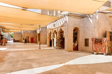 Papier Peint photo Lavable Dubai Stretched fabric that provides shade from the sun on the street in reconstructed old part of the Dubai city - Al-Bastakiya quarter in the Dubai city, United Arab Emirates