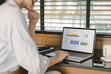 A female analyst analyzes KPI Business Analytics Data Dashboard Management System on a computer.