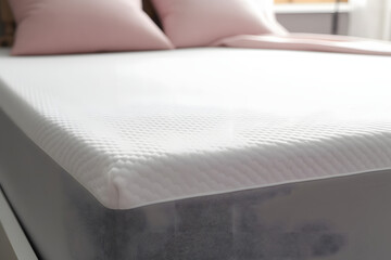 White memory foam mattress topper on grey bed, closeup - obrazy, fototapety, plakaty