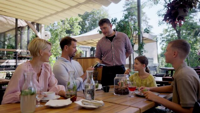 Man paying for lunch in a restaurant by card.