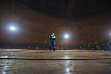 Male worker inspection visual tank oil steel