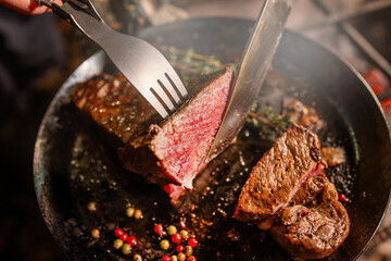 ワイルドに焼くステーキ　Grill a steak over an outdoor - obrazy, fototapety, plakaty