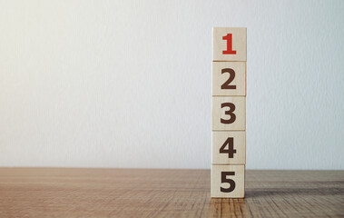 wooden cube with number 1 on wood cube stack alphabet 2 3 4 5 on wood table. Arrange to do list,...