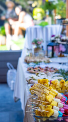 table with fruit skewers