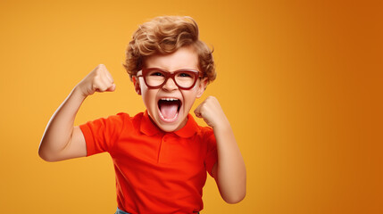 Funny little power super hero kid showing muscles. Strength, confidence or defense from bullying. yellow background. - obrazy, fototapety, plakaty