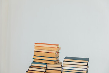 Stacks of educational books in university library on white background