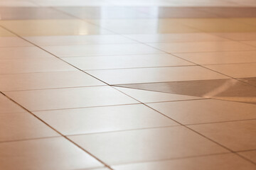 Combination of floor ceramic tiles of different sizes and shapes. Selective focus.