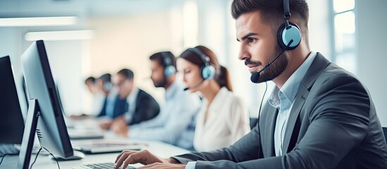 Call center workers with headphones are working at a modern office, how can I assist? - obrazy, fototapety, plakaty