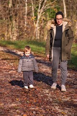 Fototapeta premium Mother with little toddler hiking in the woods